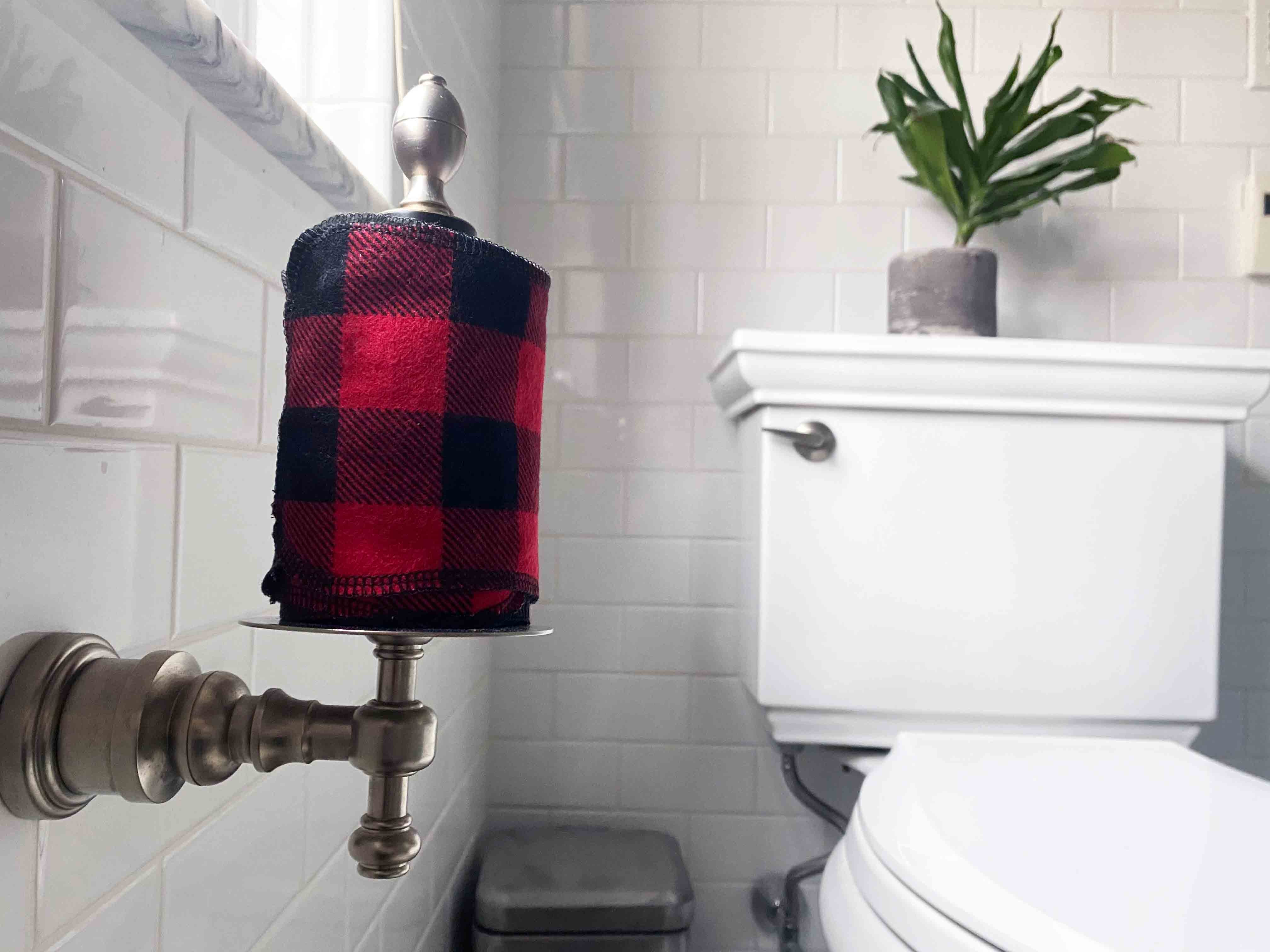 roll of cloth toilet paper in front of toilet